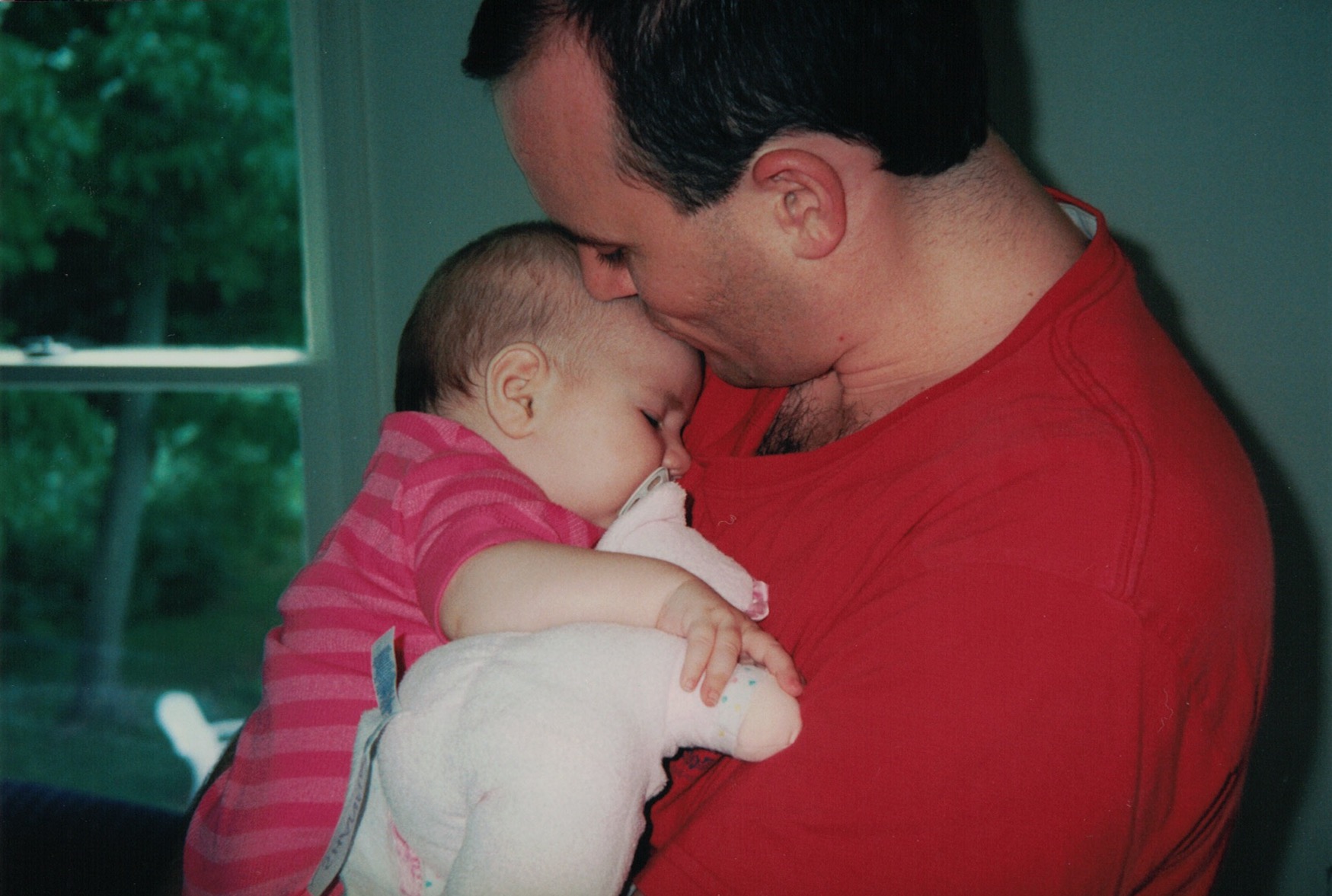 Family photo of my dad holding my sister as a baby